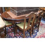 A George III style mahogany extending dining table and a set of six Hepplewhite style dining