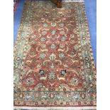 A Persian Red ground rug 220 x 138cm