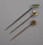 Three stick pins, including diamond and seed pearl and 9ct gold gem set.