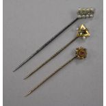Three stick pins, including diamond and seed pearl and 9ct gold gem set.