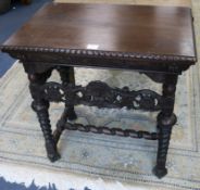 A Flemish style carved walnut side table, with carving matching the throne chair selling as Lot