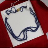 An Italian triple strand facetted sapphire bead necklace with 18ct gold clasp, approx. 49cm.