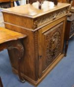 A carved oak cupboard W.92cm