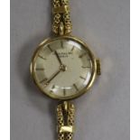 A lady's 18ct gold Patek Philippe manual wind wrist watch, with baton numerals, on an associated