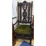 A late 19th century walnut throne chair, with carving matching that on the table selling as Lot