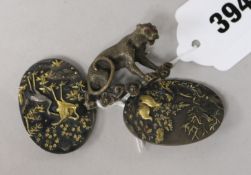 A Japanese shakudo work belt buckle and a bronze big cat brooch