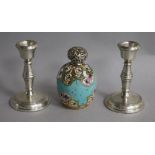 A pair of silver candlesticks and a silver topped porcelain scent bottle.