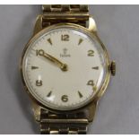 A gentleman's 9ct gold Tudor manual wind wrist watch, on an associated 9ct gold bracelet.