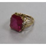 A yellow metal and synthetic ruby? dress ring, size M.