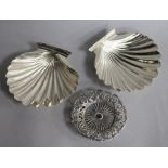 A pair of white metal butter shells and a late Victorian pierced silver nut dish.