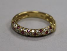 A modern 18ct gold and pave set diamond and ruby half hoop ring, size N.