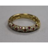 A modern 18ct gold and pave set diamond and ruby half hoop ring, size N.