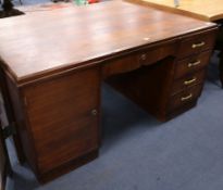 An Art Deco mahogany and oak partner's desk W.148cm