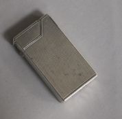 A Dunhill engine-turned silver cigarette lighter, patent no. 440072, London, 1948, 59mm.