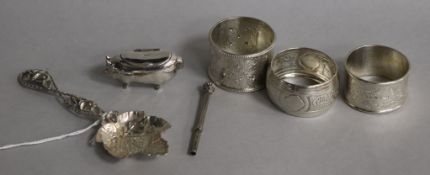 A continental silver pig box, a white metal caddy spoon, a propelling pencil & three silver napkin