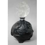 A black Lalique-style glass scent bottle