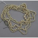 A long single strand graduated baroque cultured pearl necklace, with 14ct white gold Mikimoto clasp,