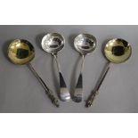 A pair of Victorian silver apostle serving spoons and a pair of George V silver Old English