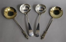 A pair of Victorian silver apostle serving spoons and a pair of George V silver Old English