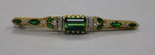 A modern 18ct gold, green tourmaline and diamond set bar brooch, 61mm.