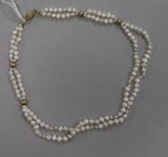 A double strand baroque cultured pearl necklace with 14ct gold clasp and spacers, 42cm.