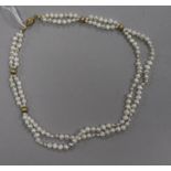 A double strand baroque cultured pearl necklace with 14ct gold clasp and spacers, 42cm.