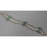 A 9ct gold fancy link and green hardstone bead necklace, 55cm.