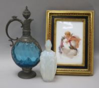 A Sabino scent bottle, a glass metal mounted ewer and a putti framed panel dated 1875
