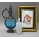 A Sabino scent bottle, a glass metal mounted ewer and a putti framed panel dated 1875