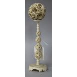 A Chinese carved ivory ball on stand