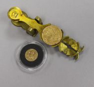 A Victoria sovereign 1892 and a Royal Mint 1/25oz gold £5 Guernsey and sovereign scales