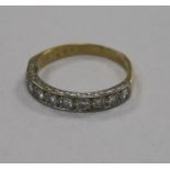 An early 1970's 18ct gold and ten stone diamond half eternity ring, size Q.