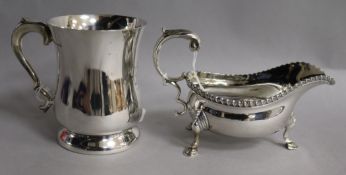 A George VI silver mug and a silver sauceboat, 13 oz.