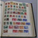 The Century Postage Stamp Album and tin of loose stamps