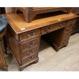 A George III style satinwood banded mahogany pedestal desk