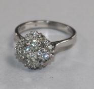 A modern 18ct white gold and diamond cluster ring of quatrefoil shape, size M.
