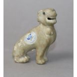 An early 18th century Chinese porcelain figure of a dog