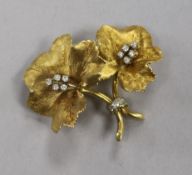 An 18ct gold and diamond set flower brooch, maker's mark PG, and numbered 5492, 40mm.