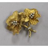 An 18ct gold and diamond set flower brooch, maker's mark PG, and numbered 5492, 40mm.