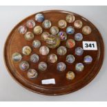 A 19th century solitaire board with latticino marbles and other antique marbles