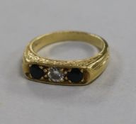 An 18ct gold and three stone sapphire and diamond ring, size O.