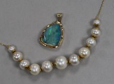 An Italian 18ct gold and graduated cultured pearl necklace and a 14ct gold and white opal pendant.