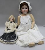 A wax headed doll and a German Bisque headed doll