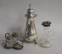A George V silver mounted whisky tot, a silver sugar caster and a part condiment set.