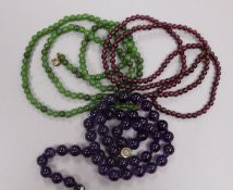 Three gem set bead necklaces, including amethyst and garnet.
