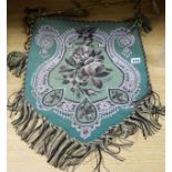 A Victorian shield-shaped beadwork adjustable fire banner, decorated with flowers on a green ground,