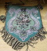 A Victorian shield-shaped beadwork adjustable fire banner, decorated with flowers on a green ground,