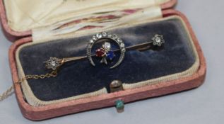 A late Victorian yellow metal, ruby, sapphire and diamond set crescent and shamrock bar brooch,