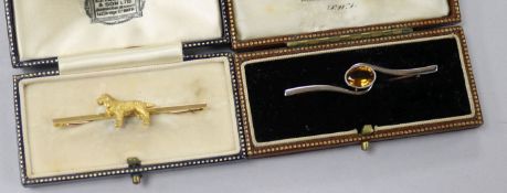 A 15ct gold dog bar brooch and a yellow and white metal gem set bar brooch.