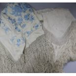 A Chinese embroidered shawl and another pale blue on cream embroidered shawl